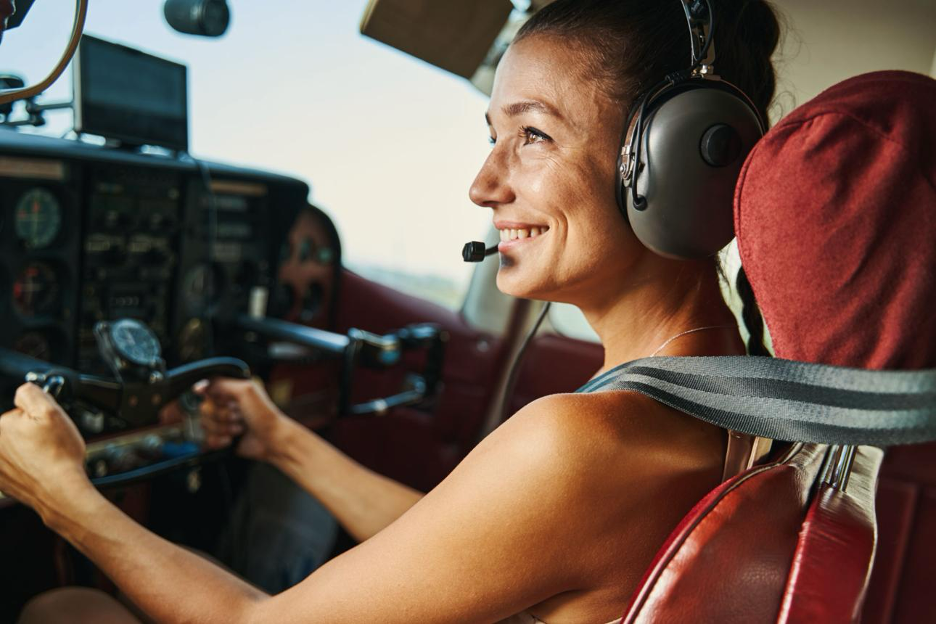 A hobby pilot smiling at the controls in golden light.
